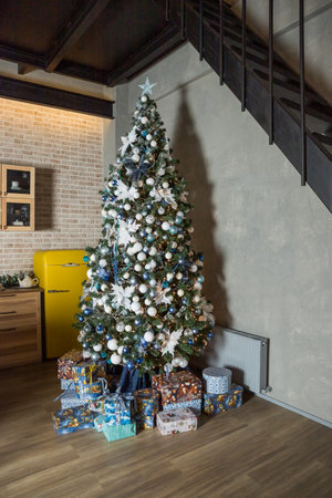 Christmas tree with blue and white toys in the interior, Christmas card with white and blue decor.Winter holidays. home decoration. Happy new yearの写真素材