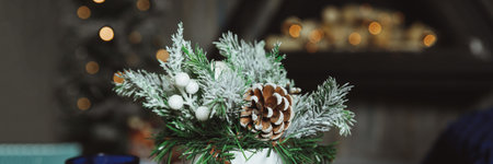 Christmas arrangement with candles. Hands close-up. decorative ornaments. Christmas decor with own...