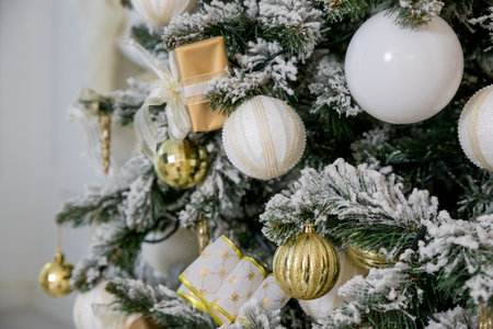 white modern christmas decoration. luxury interior with Christmas tree decorated, golden textile, golden presents,balls .festive tree decorated with garland, baubles, traditional celebrationの写真素材