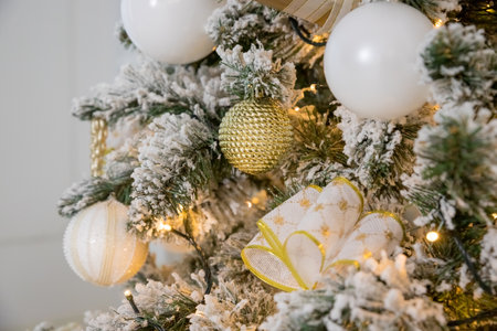 white modern christmas decoration. luxury interior with Christmas tree decorated, golden textile, golden presents,balls .festive tree decorated with garland, baubles, traditional celebrationの写真素材