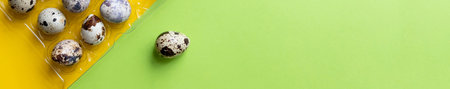 Creative layout with Fresh organic quail egg on bright yellow background. Quail eggs pattern. Happy easter concept. Minimal design. Copy space, flat lay, from aboveの写真素材