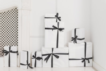 Packaging box studio shot of black and white box wrapping ribbon with bowknot - isolated on white backgroundの写真素材