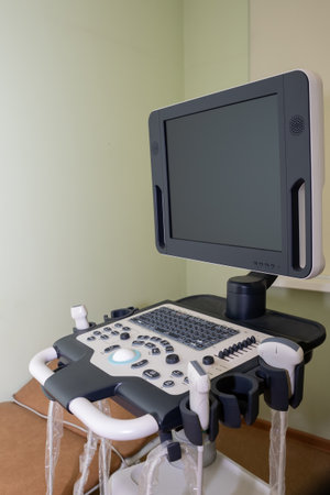 Ultrasound machine with sensor close-up. The sensor of the ultrasound machine in the doctor's hand on the background of ultrasound.の写真素材
