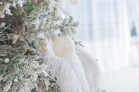 white, silver, snowflake toy hanging on the Christmas tree. White snow-covered Christmas tree. Background for holiday decoration. New Year holiday.の写真素材