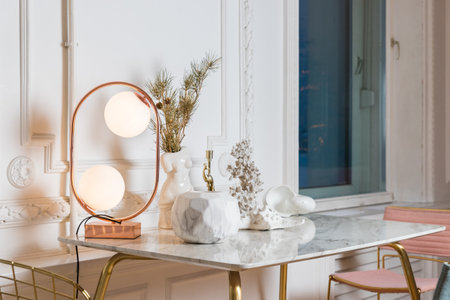 stylish illuminated table lamp .Aesthetic interior of living room. marble table with table lamp with round glass, simple console with stylish accessories. Home decor. Template.の写真素材