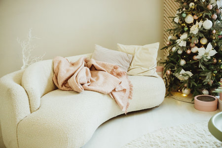 Calm image of interior luxury home living room decorated christmas tree and gifts, sofa covered with blanket.Beautiful New Years decor. home decorationの写真素材