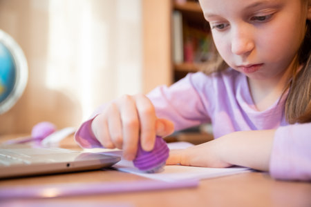 Pretty stylish schoolgirl studying homework math during her online lesson at home, social distance during quarantine,online education concept, home schooler.Online Lesson.の写真素材