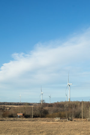 windmills turbines and a blue sky generating electricity green energy energy transition. alternative energy.Windmills and agricultural fields. Eco power. copy spaceの写真素材