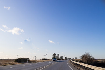windmills turbines and a blue sky generating electricity green energy energy transition. alternative energy.Windmills and agricultural fields. Eco power. copy spaceの写真素材
