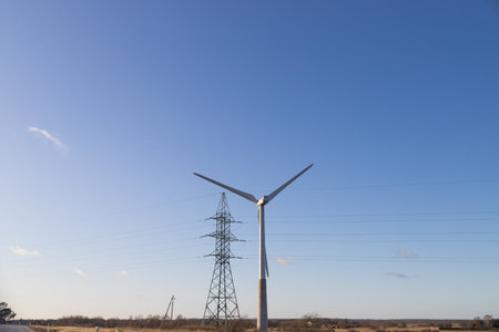 windmills turbines and a blue sky generating electricity green energy energy transition. alternative energy.Windmills and agricultural fields. Eco power. copy spaceの写真素材