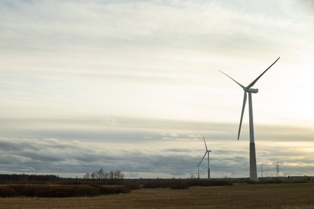 windmills turbines and a blue sky generating electricity green energy energy transition. alternative energy.Windmills and agricultural fields. Eco power. copy spaceの写真素材