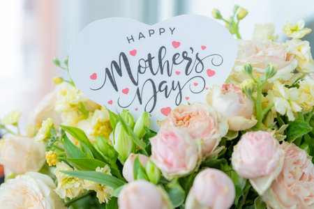 Happy Mothers Day greeting label and beautiful flowers.Close up of a beautiful bouquet of roses with a happy mothers day card.event design concept.Big bunch of fresh pink rosesの写真素材