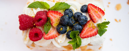 Tasty roll cake stuffed with cream cheese ,decorated with fresh strawberry, berries. Homemade...