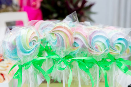 Colorful meringue cookies. A close-up shot of vibrant meringue cookies, sweetness. round meringue lollipops.Festive sweet table for children. Candy Barの写真素材