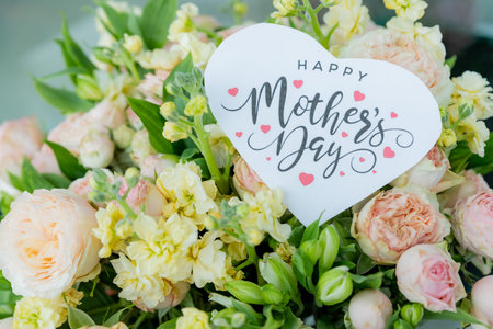 beautiful floral bouquet with a happy mothers day card , featuring pastel roses, lisianthus, and...