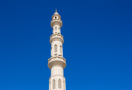 Beautiful details of the minaret of the New Mosque in Hurghada, part Sakalla in Egypt. Bright sunny day, clear blue sky.の写真素材