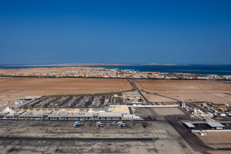 View on the buildings of the international airport in Hurghada, Egypt. City in the background together with sea. Blue clear summer sky.の写真素材