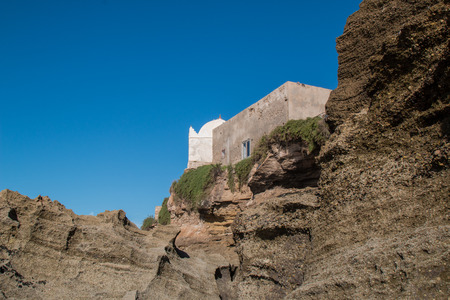 Small mosque in the village on the coast of Atlantic Ocean in Morocco, Moulay Bouzerktoun. Bright blue sky.の写真素材