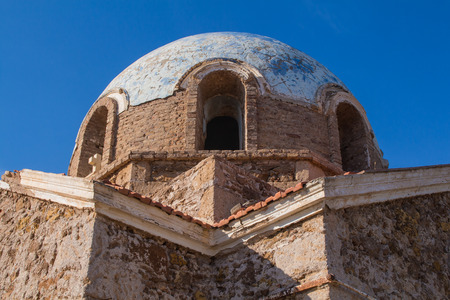 Abandoned church od Saint John (Agios Ioannis) in the country close to Cape Sounion in Greece. View on the exterior of the dome and roof. Bright blue sky.の写真素材