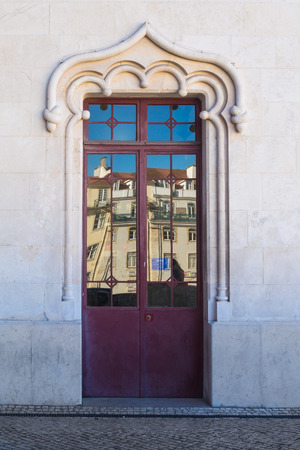 Door of a building with a reflection of another houses. Bright blue sky. Lisbon, Portugalの写真素材