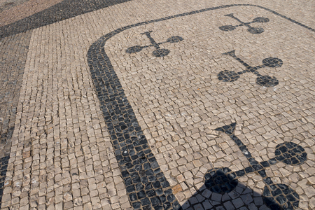 Portuguese street paved by black and white cobblestones. Design of a playing card. Armacao de Pera, Algarve, Portugal.の写真素材