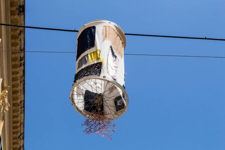 Colorful lampion - street light, hanging on a cord cross a street. Bright blue sky. Alghero, Sardinia,  Italy.の写真素材