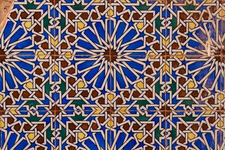 Detail of a colorful tiles with traditional geometrical floral motive. Wall in an abandoned house. Dar Caid Hadji (used also Hajji), south of Safi, Morocco.の写真素材