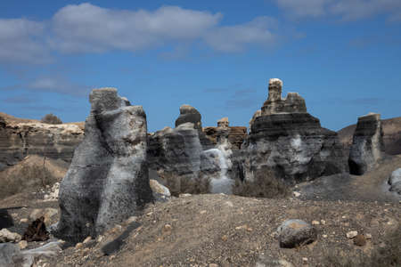 Vulcanic soil and objects, which are similar to statues, created by the nature. Blue sky with white clouds in the spring. Lanzarote, Canary Islands, Spain.の写真素材