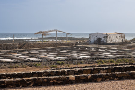 Museum of traditional way of production the salt at the coast of the Atlantic ocean. Bright blue sky with light clouds. Salinas del Carmen, Fuerteventura, Canary Islands, Spain.の写真素材