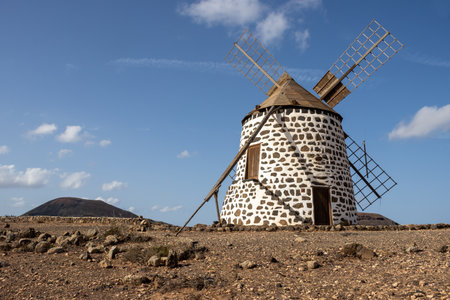 Historical well preserved round shaped windmills, built on a hill. Blue sky. Molinos de Villaverde, Fuerteventura, Canary Islands, Spain.の写真素材