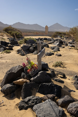 On the Atlantic ocean beach, place which belongs to nobody and everybody, was built a cemetery for local inhabitants. Crosses and tombstones among the sand of the beach. Cofete, Fuerteventura.の写真素材
