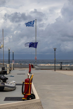 Promenade of the city beside the Ionian (Mediterranean) sea. Fire extinguisher in the foreground....
