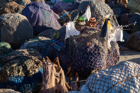 Packs of fishing nets, stored in the port. Morning sunlight. Port of Essaouira, Morocco.