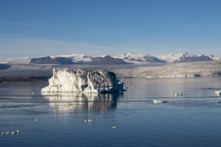Huge pieces of glacier, floating in the water of lagoon. One of the attractions of the island. Blue...