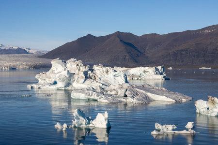 Huge pieces of glacier, floating in the water of lagoon. One of the attractions of the island. Blue...