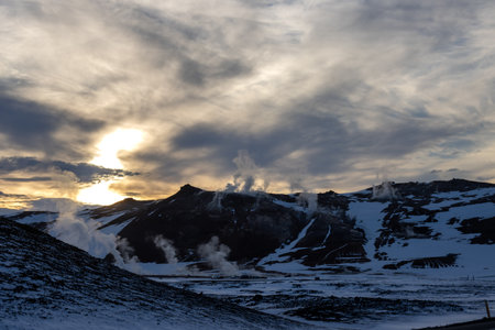 Area, where the geysers are appearing very often and the geothermal activity is viisble also on the unfrozen lines in the snow. Early sunset in the North-Central part Myvatn, Iceland.の写真素材