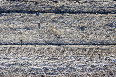 Natural wooden tiles, floor of the bridge. Bright sunshine. Thin layer of a snow. North Iceland.の写真素材