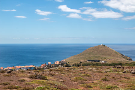 Cliffs of the peninsula and Atlantic ocean during sunny day in the spring. Blue sky with white clouds. Vulcao Penha de Aquia, Madeira, Portugal.の写真素材