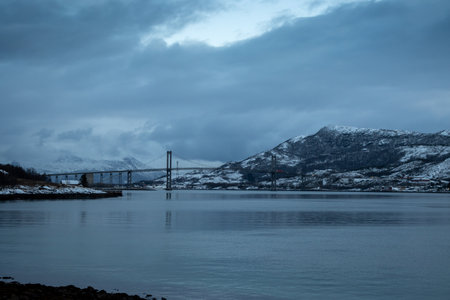 Bridge connecting the islands. Blue mood of all the landscape in the northern morning. Cloudy sky. Tjeldsundbrua, Norway.の写真素材
