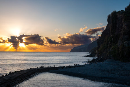 Atlantic ocean and sunset. Cloudy colorful sky. Coastal cliffs. Ponta do Sol, Madeira, Portugal.の写真素材