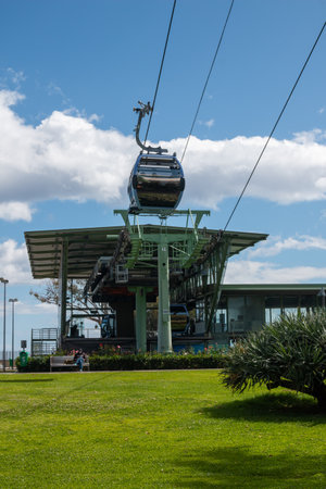 Funicular station in the downtown. One cabin leaving up the hill. Bright green grass. Blue sky with white clouds. Funchal, Madeira, Portugal.の写真素材