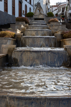 Cascade fountain lined by staircases on both sides and residential houses in the historical part of the town. Firgas, Las Palmas, Gran Canaria, Canary Islands, Spain.の写真素材