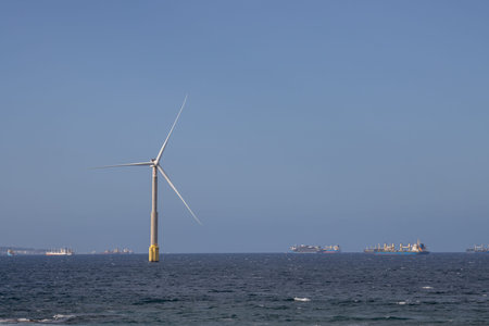 Wind turbine built in Atlantic ocean. Many boats on the horizon. Bright blue sky. Telde, Las Palmas,...