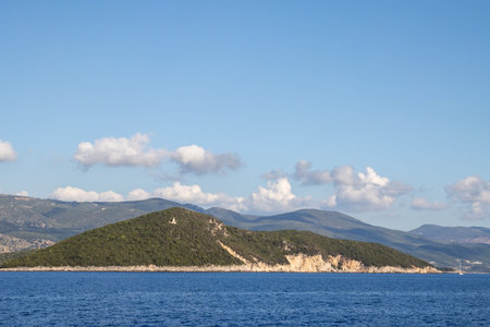Ionian see between Greece and Albania. Albanian mountains in the background. Sky with clouds....