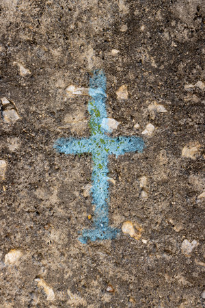 Detail of a blue painted cross on an old wall, made of stones. Paxos, Greece.の写真素材