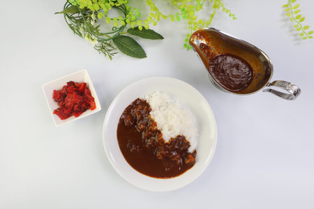 Curry and rice and the fukujinzuke which were placed in the white table.の写真素材