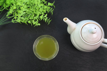 green tea  poured from a teapot.の写真素材