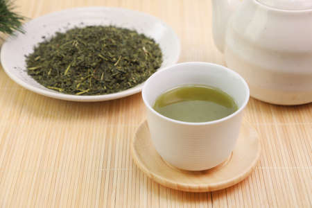 green tea  poured from a teapot.の写真素材