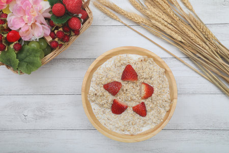 The oatmeal which served a strawberry to a bowl.の写真素材