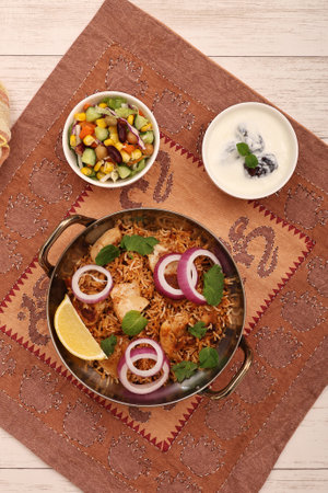 chicken biryani served with yoghurt and vegetable saladの写真素材